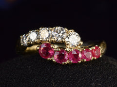 thumbnail of Front profile of c1970 Yellow Gold Ring with rows of pink rubies and white diamonds curling around each other. On dark background.