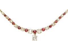 thumbnail of Close up on a vintage yellow gold necklace with alternating red rubies and old mine cut diamonds, shown on white background.