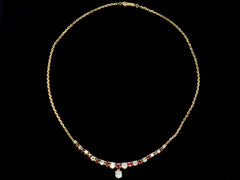 thumbnail of A vintage yellow gold necklace with alternating red rubies and old mine cut diamonds, shown on black background.