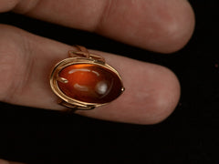 thumbnail of Vintage ring with an oval amber cabochon in 14k rose gold, shown on finger