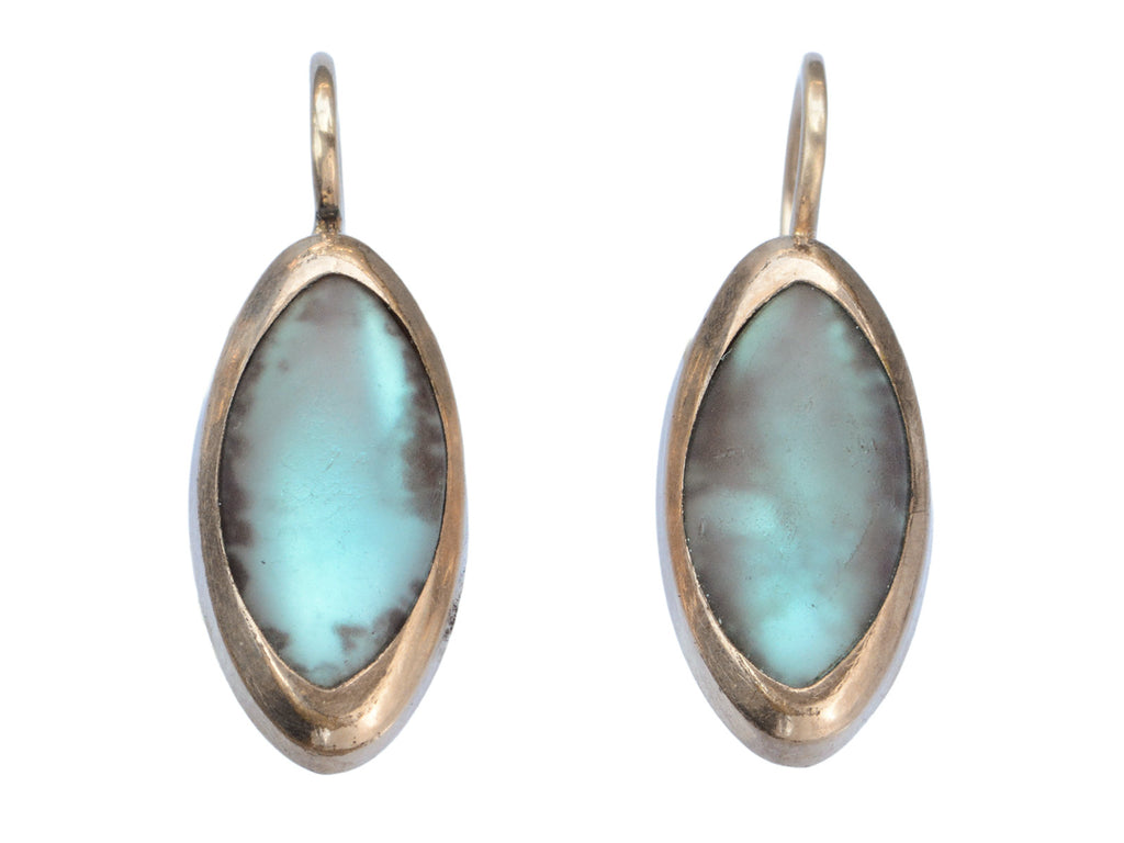 Pair of gold earrings with marquise shaped iridescent pale blue saphiret cabochons, shown on white background.