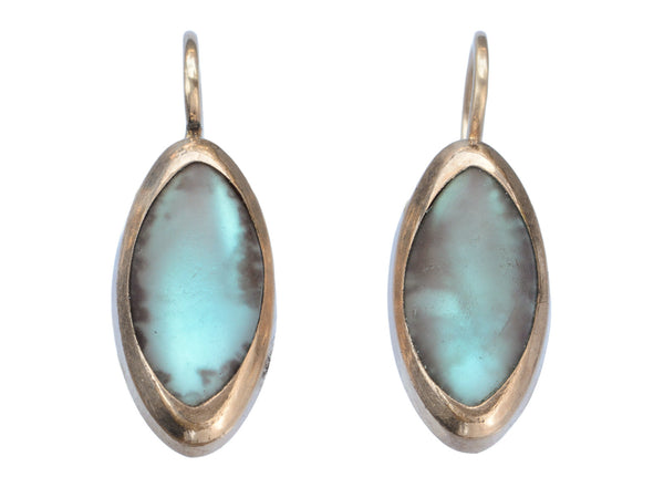 Pair of gold earrings with marquise shaped iridescent pale blue saphiret cabochons, shown on white background.