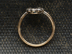 thumbnail of Side profile of antique silver topped gold ring with blue and white sapphires (shown on dark background)