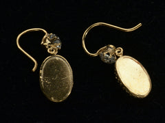 thumbnail of Backside of yellow gold earrings with white crystal tops and oval pendants. Shown on black.