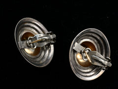 thumbnail of Reverse side view of pair of vintage yellow gold and silver flying saucer shaped earrings on black background.