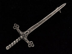 thumbnail of A Scottish silver sword pin, shown on black background