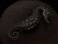 thumbnail of Angled view of c1970 Darkened Silver Seahorse Brooch on dark textured background.