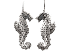thumbnail of A pair of silver seahorse drop earrings textured with disks, shown against a plain white background.