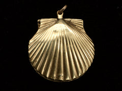 thumbnail of Front side of an antique Victorian scallop shell locket in gold, on black background