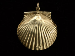 thumbnail of Reverse side of an antique Victorian scallop shell locket in gold, on black background