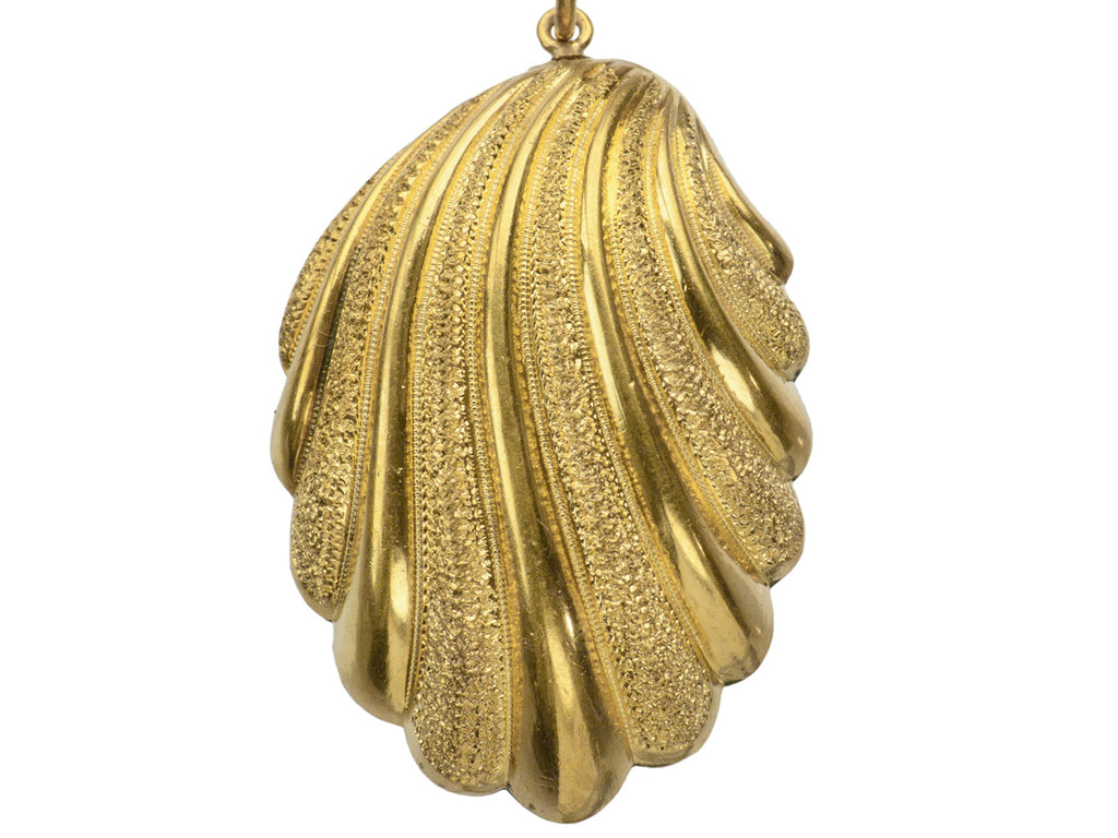 Detail of Victorian shell pendant necklace with detailed gold work, shown on white background.