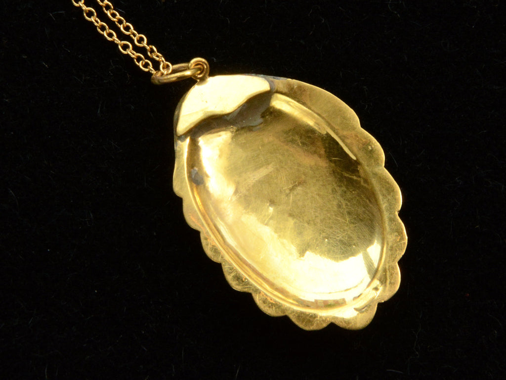Reverse side of Victorian shell pendant necklace on black background. Traces of old lead solder visible.