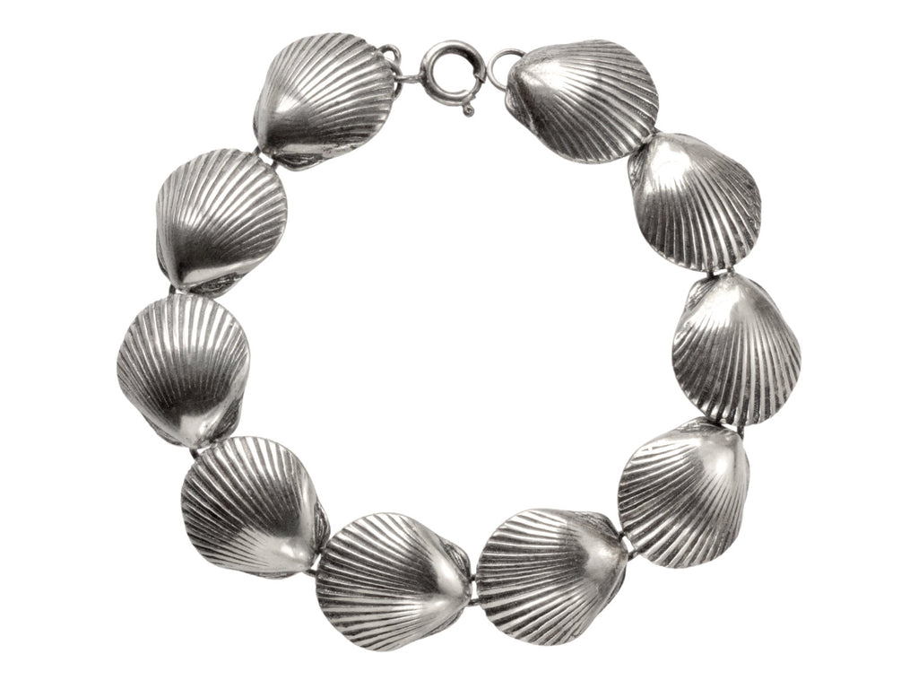 A silver bracelet with scallop shell links, on white background.