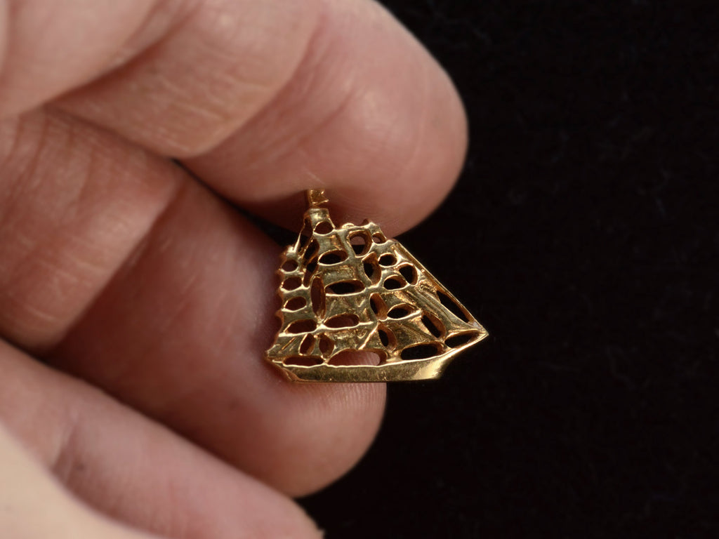 c1960 Vintage Yellow Gold Tiffany & Co Tie Tack depicting a clipper ship, shown on hand.