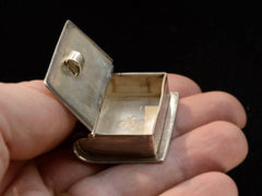 thumbnail of c1970 Silver Book Box (shown open on hand for scale)