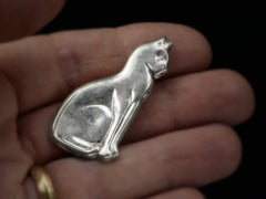 thumbnail of A vintage silver cat brooch shown held in hand