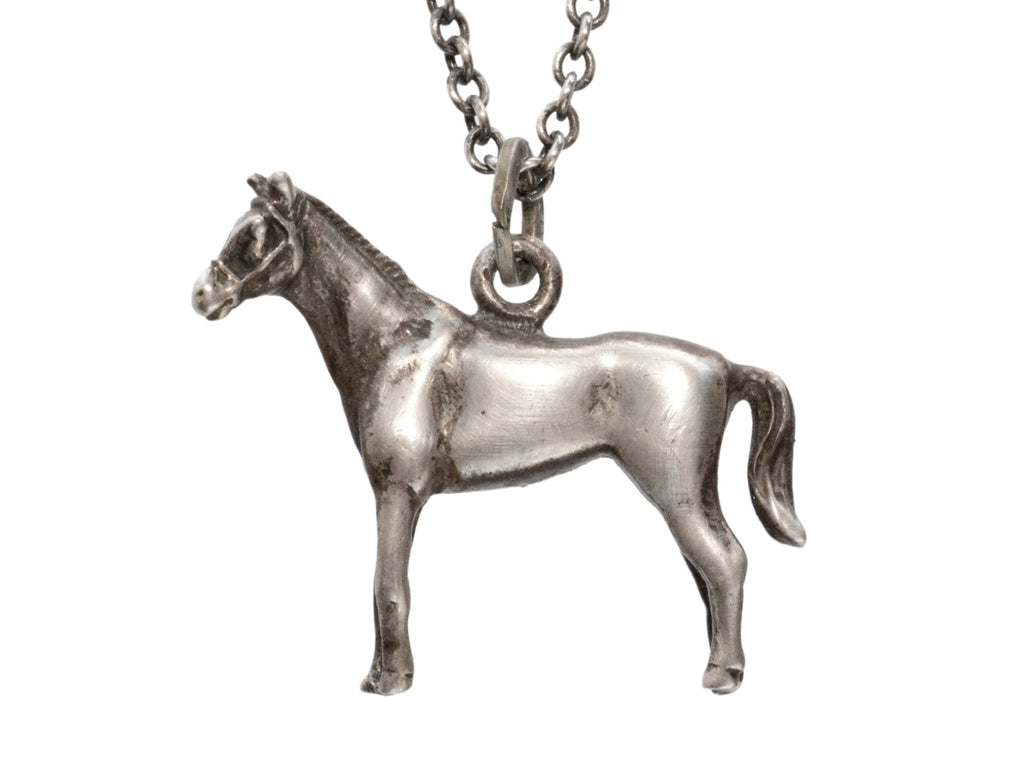 Silver horse pendant on a chain against a white background

