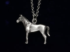 thumbnail of Silver horse pendant on a chain against a black background