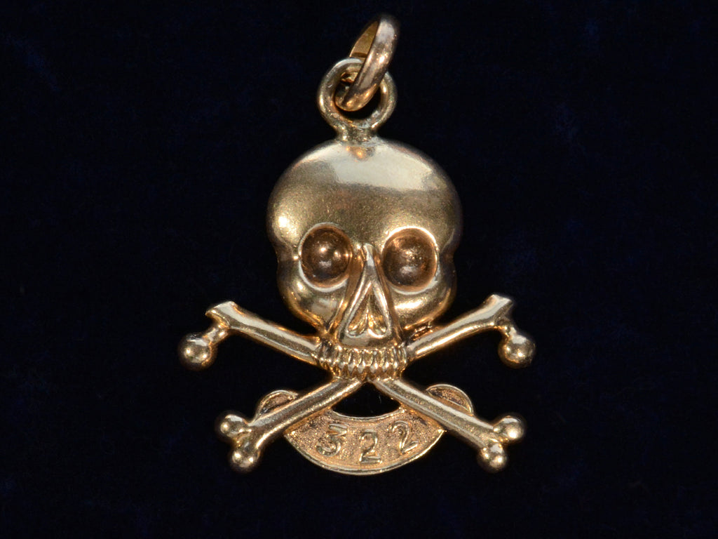 c1920 Skull & Bones Charm with the number 322 (shown on black background)