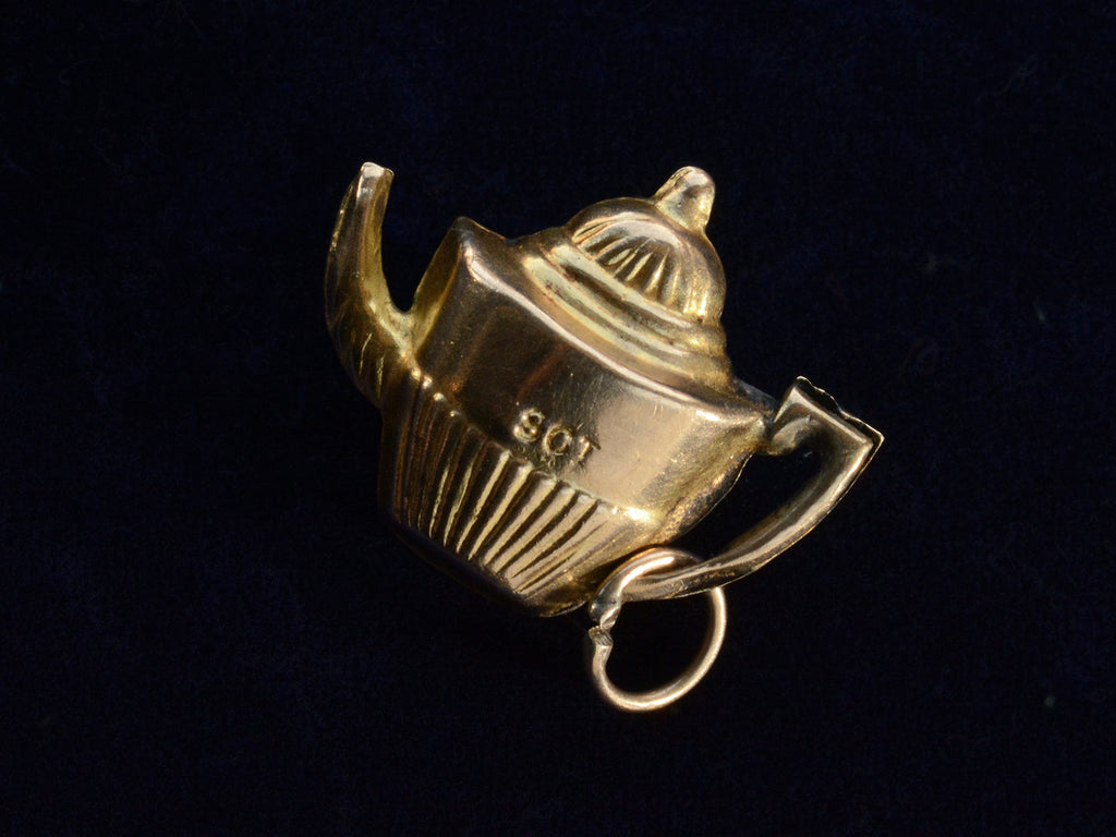 Reverse side of c1960 Gold Teapot Charm, showing "9CT" stamp (on black background)