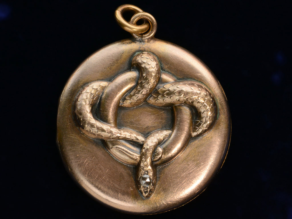 c1890 Rose Gold Colored Snake Locket with Diamond Head (shown on black background)