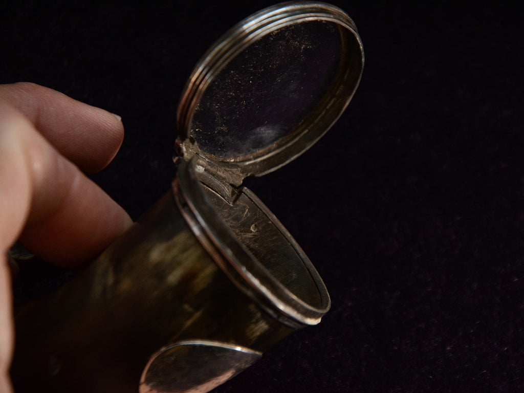 Detail view showing open glass lid of snuff box.