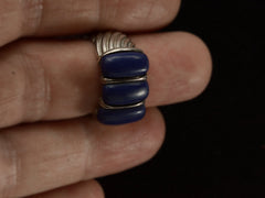 thumbnail of A silver ring featuring three polished dark blue resin stones, shown worn on a finger
