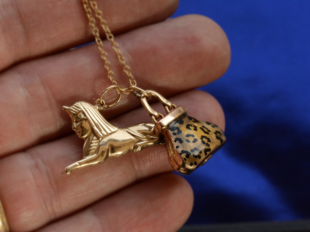 c1970 Sphinx & Purse Charms in yellow gold with cheetah print enamel. Shown on hand for scale.