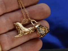 thumbnail of c1970 Sphinx & Purse Charms in yellow gold with cheetah print enamel. Shown on hand for scale.