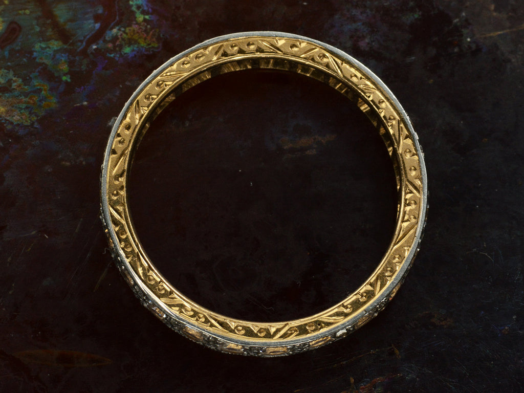 Side profile of c1920 Gold and Platinum Eternity Band with Carvings on Side on dark background)