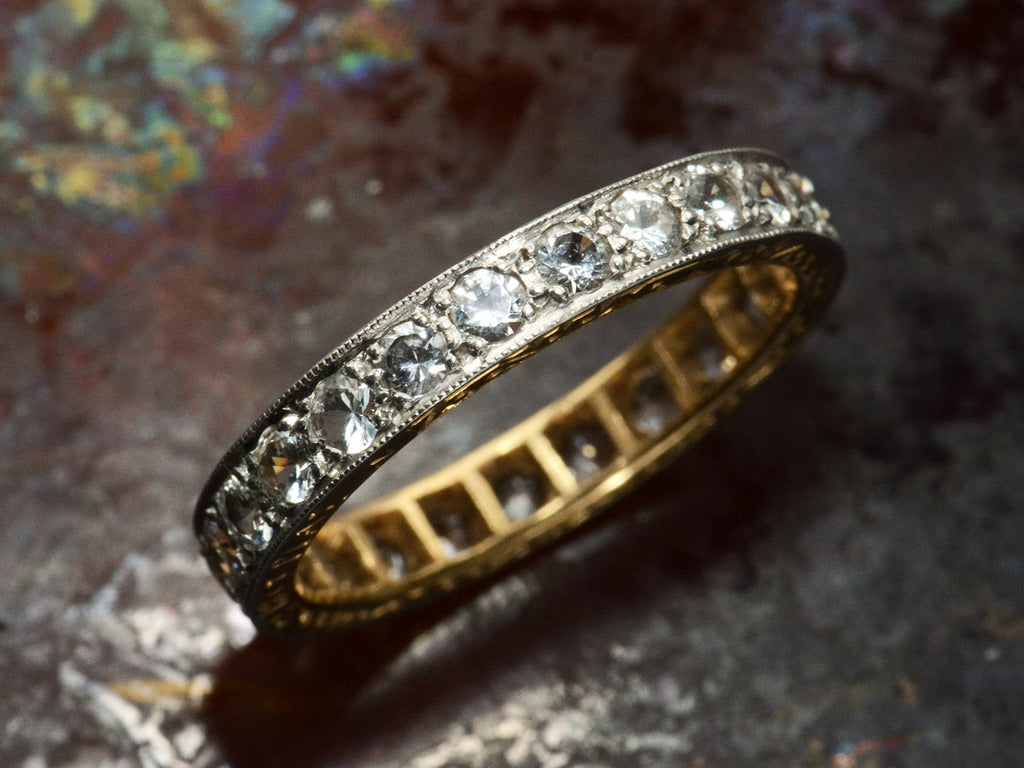 Angled view of c1920 Gold and Platinum Eternity Band Set with White Spinels (on dark background)