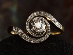 thumbnail of Front profile of antique Art Nouveau spiral form with diamonds in platinum-topped gold, shown on dark background.