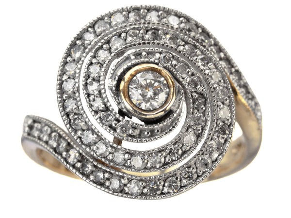 A vintage spiral form ring with diamonds in a white gold topped yellow gold mounting, shown on white background.