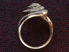 thumbnail of Side profile view of a vintage spiral form ring with diamonds in a white gold topped yellow gold mounting, shown on dark background.