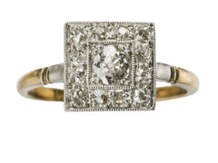 thumbnail of An antique platinum topped yellow gold square cluster ring with old cut diamonds, shown on white background.
