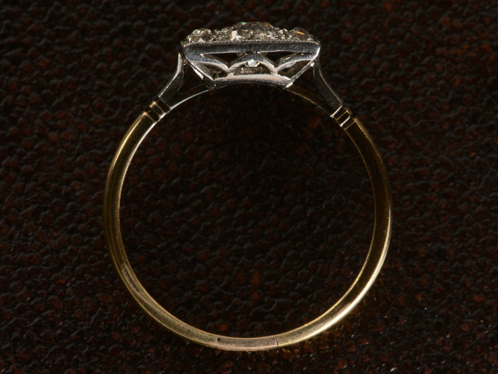 Side profile of antique platinum topped yellow gold square cluster ring with old cut diamonds, shown on dark textured background.