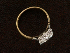 thumbnail of Angled view of antique platinum topped yellow gold square cluster ring with old cut diamonds, shown on dark textured background.