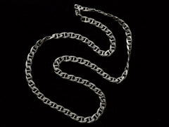 thumbnail of A vintage sterling silver chain with beveled, flattened curb links, with texture on one side, shown on black background.