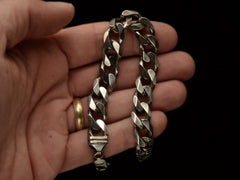 thumbnail of A vintage Italian sterling silver chain bracelet with beveled curb links held in hand.