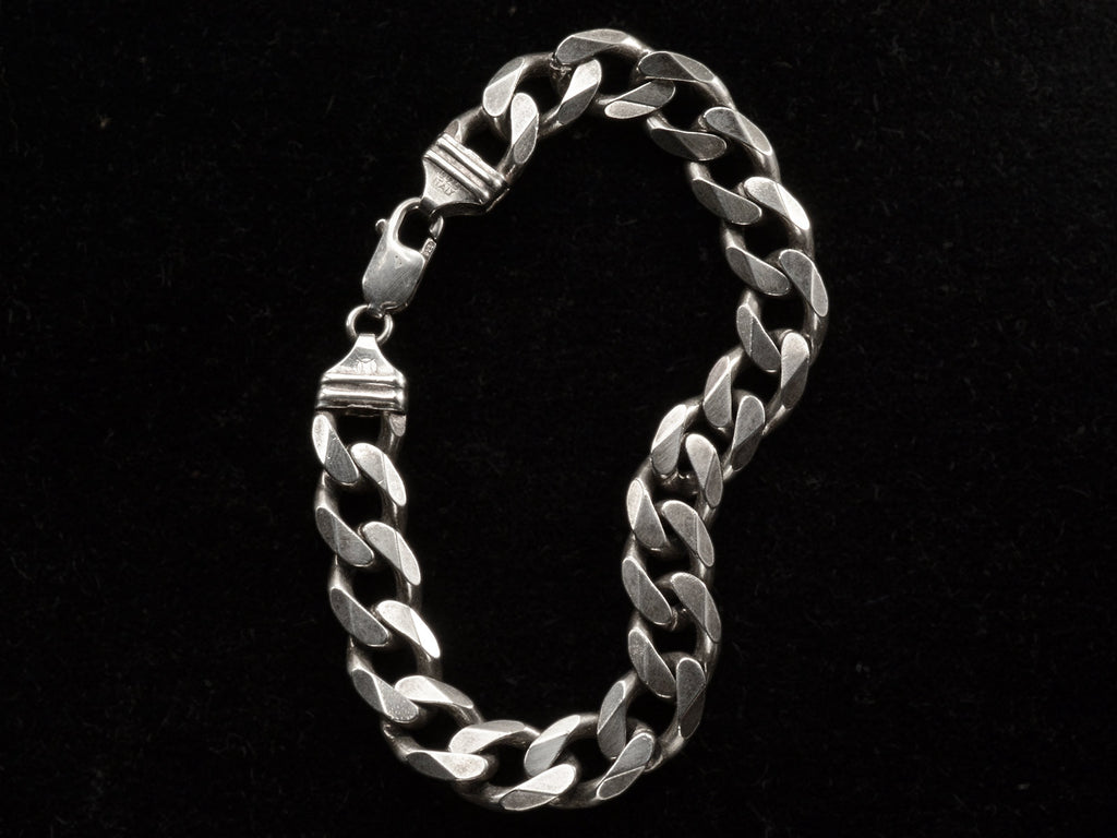 A vintage Italian sterling silver chain bracelet with beveled curb links on black background. "ITALY" and "925" stamps visible.