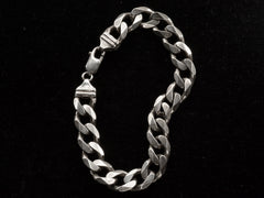 thumbnail of A vintage Italian sterling silver chain bracelet with beveled curb links on black background. "ITALY" and "925" stamps visible.