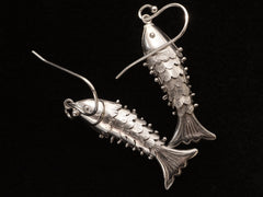 thumbnail of Reverse side of silver articulated fish earrings, on black background. "SILVER" stamp visible.