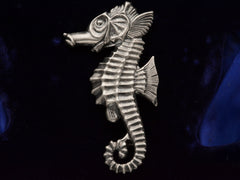 thumbnail of Front side of large vintage c1950 sterling silver seahorse brooch on dark background.