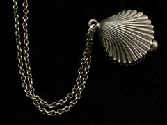 thumbnail of Detail of antique silver shell pendant on a chain against a black background