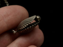 thumbnail of Antique silver shell pendant held in hand