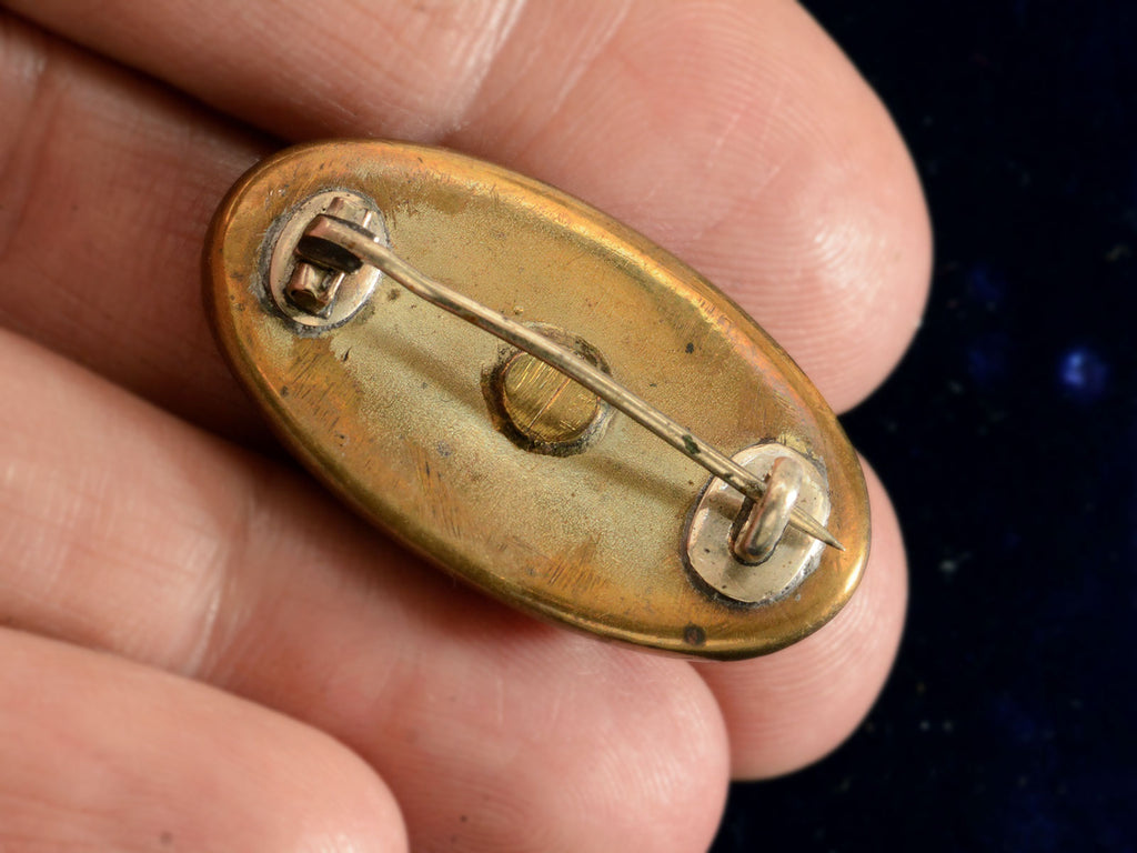 c1900 Marbled Turquoise and Red Glass Pin (on hand showing reverse side)