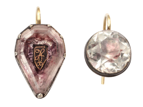 Mismatched earrings made from pink foiled silver set buttons on gold ear wires. On white background.