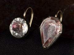 thumbnail of Angled front view of mismatched earrings made from pink foiled silver set buttons on gold ear wires. On black background.