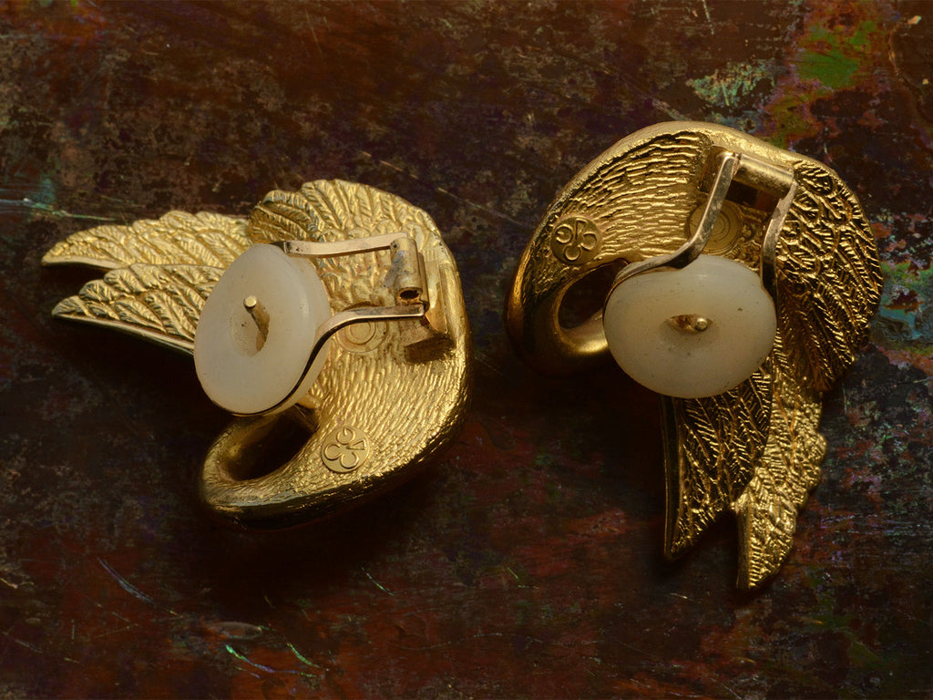Reverse side of of vintage swan-shaped 18K yellow gold earrings, showing posts and backs and "CG" hallmark for Charles Garnier.