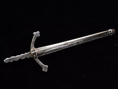 thumbnail of Reverse side of large silver sword brooch showing tiny hallmarks and "MADE IN SCOTLAND" stamp.